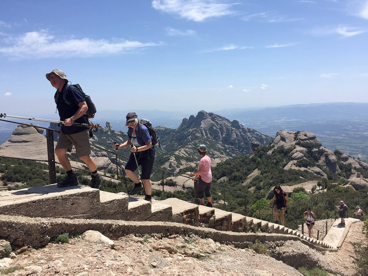 climbing-montserrat Image of hikers climbing a path in the mountain of Montserrat