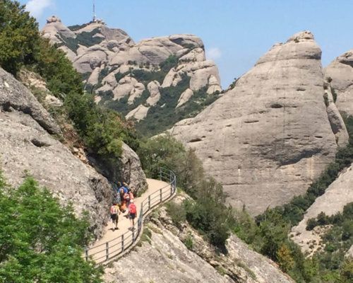 Image featured Hikers in Montserrat. Tour Montserrat Monastery & Hiking Experience. Hiking in Mountain of Montserrat