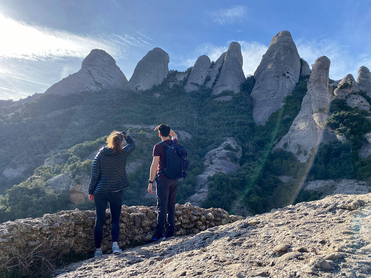 trail-in-montserrat Walking trail in Montserrat. Image of hikers climbing a trail in the Montserrat mountain